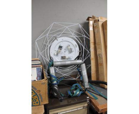 A metal ceiling light together with a bike carrier