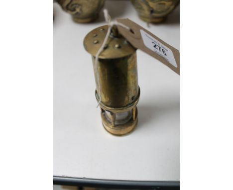 A miniature brass miner's lamp 