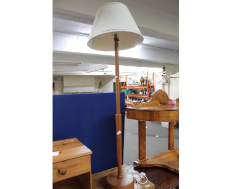 A teak standard lamp and shade 