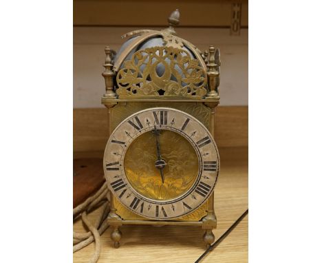 R. Arnold Bodmin, a lantern clock on wooden wall shelf, clock 32cm high