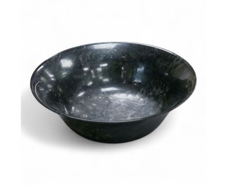 A Chinese spinach green jade bowl, 21cm diameter