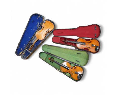 Three violins; a late 19th century German Stradivarius pattern violin, without label, a handmade violin (a.f.), with sound po
