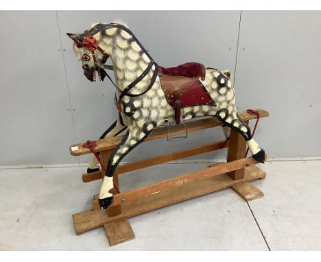 A mid-20th century dapple grey rocking horse, probably by Collinson, with corduroy and leather saddle and painted wooden body
