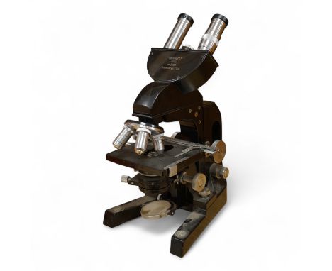 A mid 20th century Reichert, Austria binocular microscope, 34cm high.