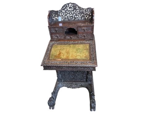 A 19th century Burmese carved hardwood Davenport, width 65cm, depth 67cm, height 122cm