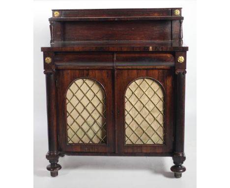 A Regency period rosewood Chiffonier, the top with a single shelf on turned supports over two frieze drawers, the base with t