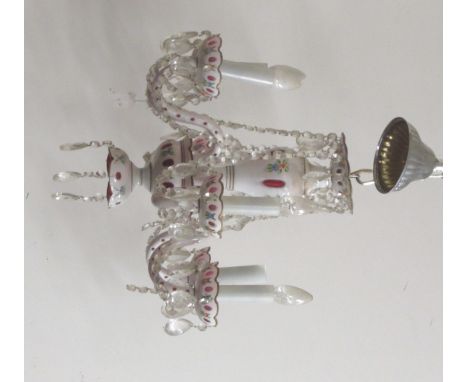 A single tier six branch coloured ruby glass Chandelier, decorated with cutglass drops and droplets, and decorated with garla