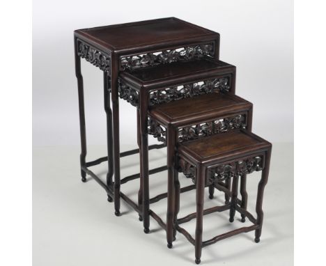 A nest of four Chinese carved hardwood Tables, each with pierced decorated fret on shaped legs, each signed in manuscript und