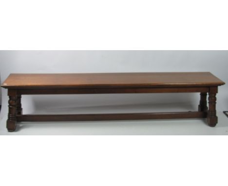 A 19th Century oak Furm / Long Bench, on turned feet with plain stretcher, approx. 7' (213cms). (1)