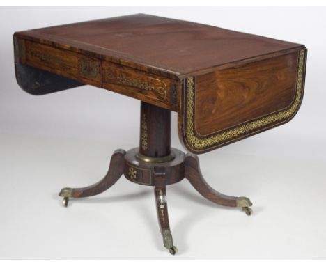 An exceptionally fine Regency period brass inlaid rosewood Sofa Table, the finely figured top with broad brass inlaid and cro