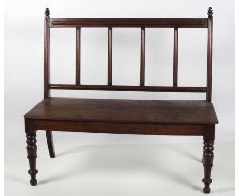 An early Victorian mahogany Hall Bench, with moulded rail back over a solid seat on turned front legs, 116cms (45 1/2") long.
