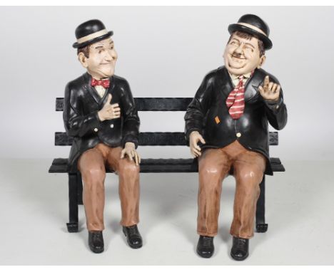 P. MookA pair of Composition Scale Model painted Figures, of Stan Laurel and Oliver Hardy, on an associated heavy cast iron b