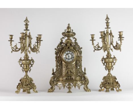 A Victorian style heavy brass Mantle Clock, the enamel dial decorated with urn, shell, flowers and grotesque masks, and with 