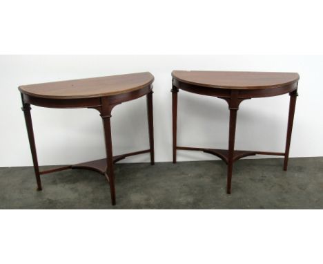 A pair of Edwardian inlaid mahogany demi-lune Side Tables, each raised on square tapering legs united by a stretcher shelf, 2