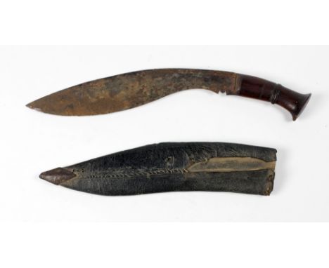 A 19th Century Nepalese Gurkha Kukri, 45.5cms (17 3/4") long with carved wooden handle and original leather scabbard. (1)