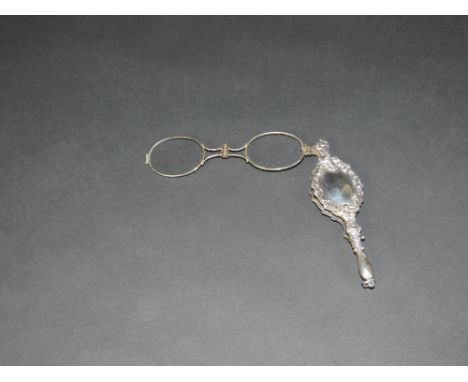 An attractive 19th Century silver and silver gilt Lorgnette, spring loaded, in an embossed case inset on one side with four c