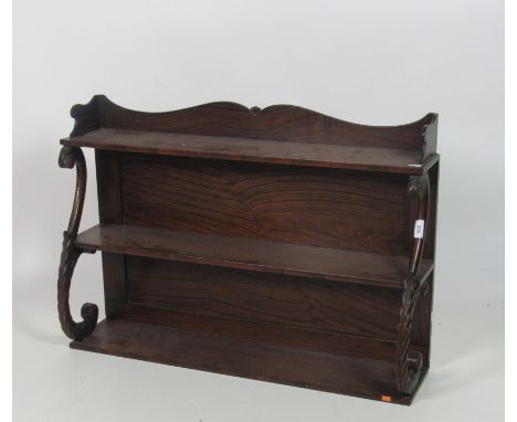 A William IV assimilated rosewood three tier Wall Shelf, the shaped top supported by carved scroll supports, approx. 61cms (2