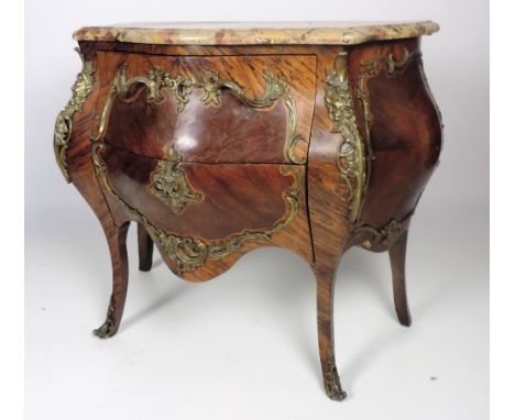 An early 19th Century Louis XV style bombé shaped Commode, in kingwood, coromandel, walnut and other woods, the serpentine sh