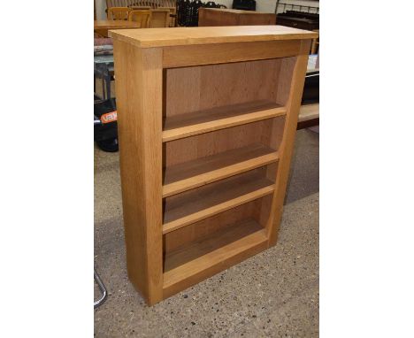 A modern light oak bookcase cabinet