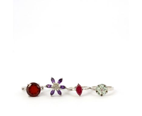 Four 925 silver stone set rings including ruby, amethyst, peridot, etc.