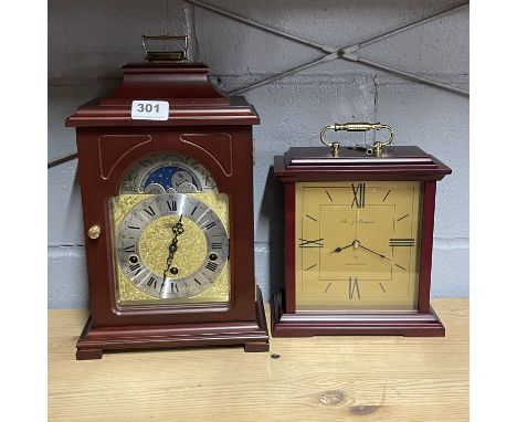 A new moon phase mantle clock, H. 34cm, together with a further mantle, new unsold jeweller's stock.