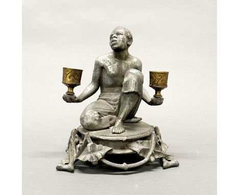 A 19thC spelter and brass figural candlestick, H. 19cm.