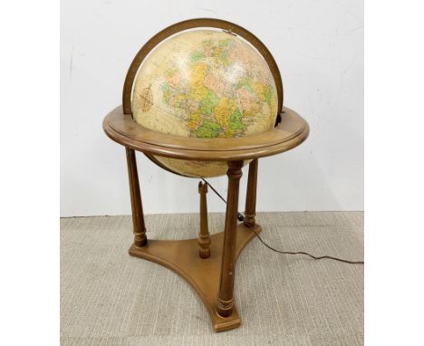 A large floor standing illuminated globe, H. 82cm.