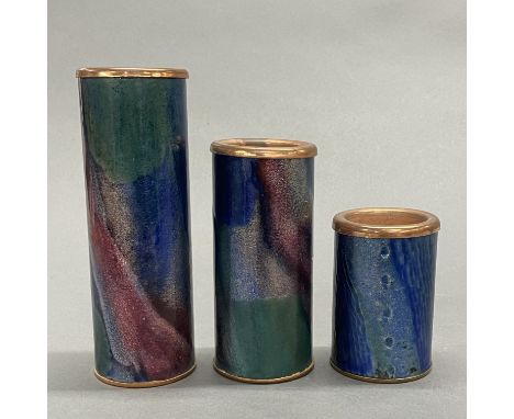 A set of three Bjornstad Norwegian enamelled copper tea light holders, tallest 16cm.