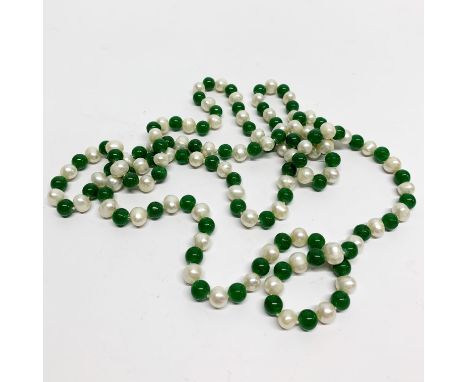 A single strand necklace of cultured pearls and jade beads, L. 120cm.