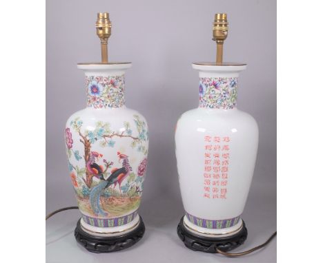 ASIAN INTERESTA pair of modern Chinese lamp bases, decorated with flowers and calligraphy, 43cm tall