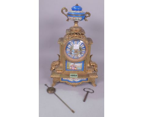 A GILT METAL MOUNTED MANTLE CLOCK WITH PORCEALIN MOUNTS
