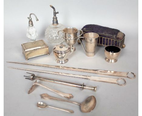 A SILVER TROPHY CUP, TWO ATOMISERS, A PLATED MEASURING CUP AND SUNDRY