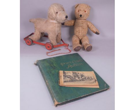 AN EARLY 20TH CENTURY TEDDY BEAR (3)An early 20th century push along teddy dog and a collection of First World War post cards