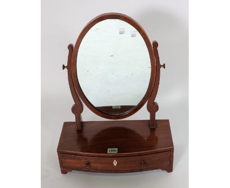 A GEORGE III INLAID MAHOGANY TOILET MIRRORWith oval mirror plate over bow single drawer base. 38cm wide &amp; 49cm