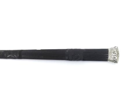 Ceremonial ebonised stick with carved fluted tapering handle and white metal mounts, 39" long