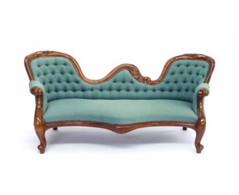 Replica double ended chaise longue in the Victorian style, with carved frame and button-back green diaper pattern upholstery,