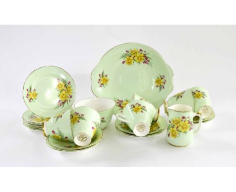 Imperial Fine English China six setting tea service, decorated with daffodils upon a pale green ground with gold plated borde