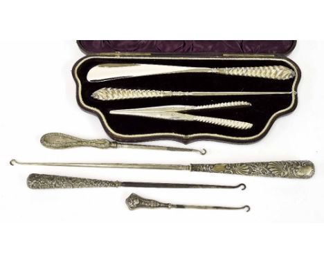 Victorian cased set to include a shoehorn, button hook and pair of glove tongs, each with silver handles, maker Adie & Loveki