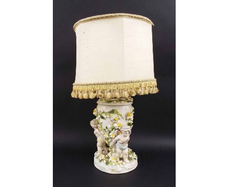19th century German porcelain floral encrusted lamp base, of oval form with applied meandering foliage supported by three sta