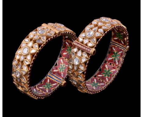  Two Indian enamel and diamond bracelets,   the hinged bangle set with lasque cut diamonds in a pierced foliate design, the i