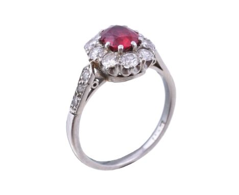  A 1930s ruby and diamond cluster ring,   the oval cut ruby estimated to weigh 0.61 carats within a surround of old brilliant