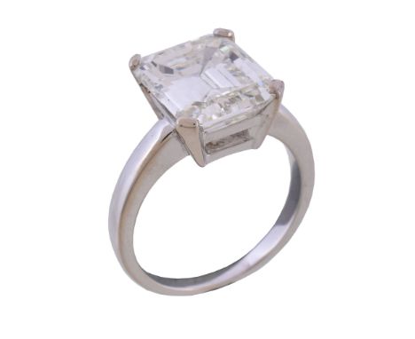  A single stone diamond ring,   the step cut diamond with canted corners, weighing 6.31 carats, in four claw setting, finger 