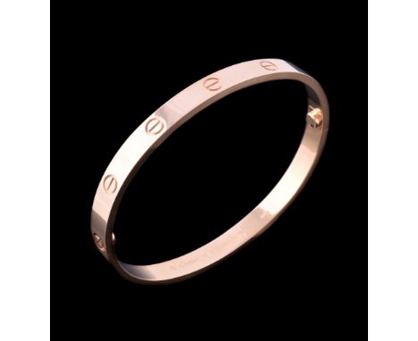  An 18 carat gold 'Love' bangle by Cartier,   the polished bracelet with screw detail, signed Cartier, stamped 750 with Swiss