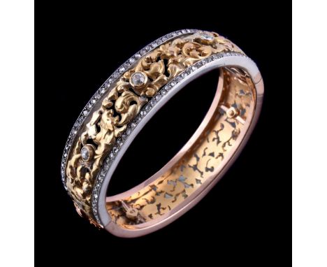  A French diamond set hinged bangle  , the bangle with pierced scrolled foliate panels, the front with rose cut diamond borde