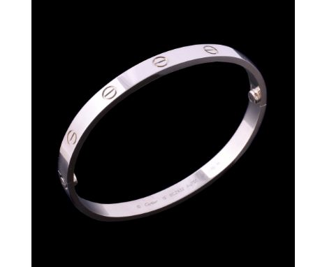  An 18 carat gold 'Love' bangle by Cartier,   the polished bracelet with screw detail, signed Cartier, stamped 750 with Swiss