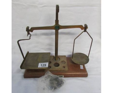 A set of postal scales with weights (one weight missing)