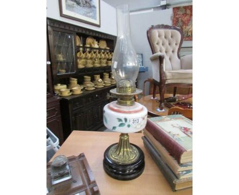 An oil lamp on pot base, with brass column and hand painted glass font