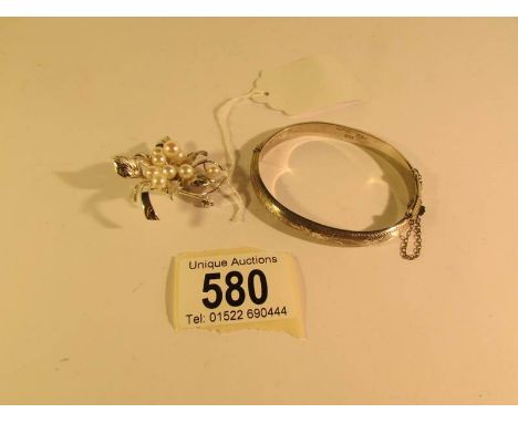 A vintage cultured pearl brooch set with 8 pearls and a silver bangle