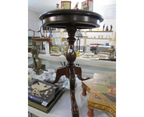 A mahogany tripod table