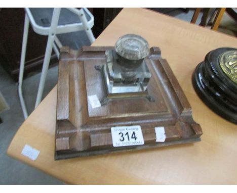 An oak desk stand with glass inkwell